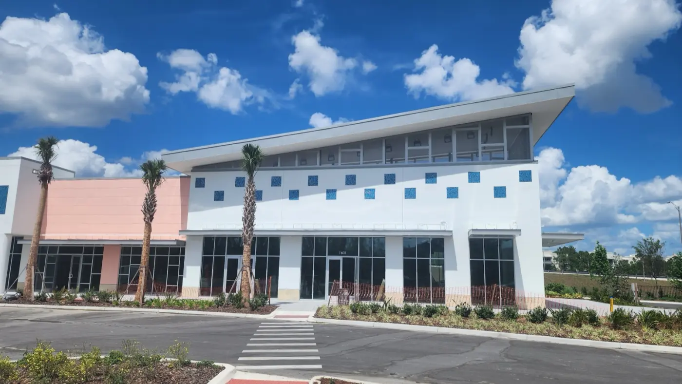 The exterior of Celebration Brewing Co. at 1601 Future Way — a modern building with palm trees under a bright Florida sky.